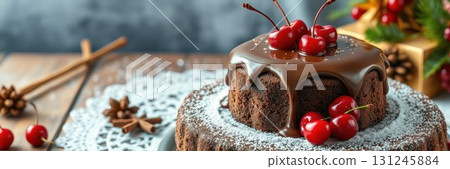 Delicious chocolate cake topped with cherries and surrounded by festive decorations during a winter celebration 131245884