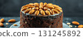 Delicious chocolate almond cake decorated with roasted nuts and shimmering glaze 131245892