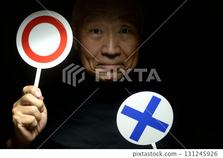 Old man holding a check mark and cross sign 131245926