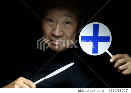 Old man holding a check mark and cross sign 131245927