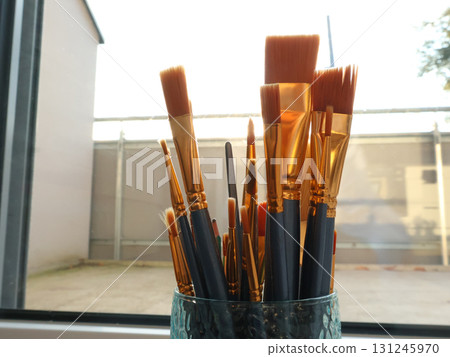 Paint Brushes in Glass Jar by Sunlit Window - Artist Studio Tools and Supplies Paint Brushes in Glass Jar by Sunlit Window - Artist Studio Tools and Supplies 131245970