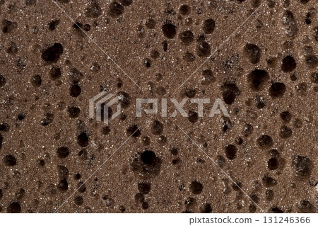 brown sponge for washing dishes or other objects, a synthetic sponge with lots of holes for good foaming of detergents and is used for cleaning 131246366