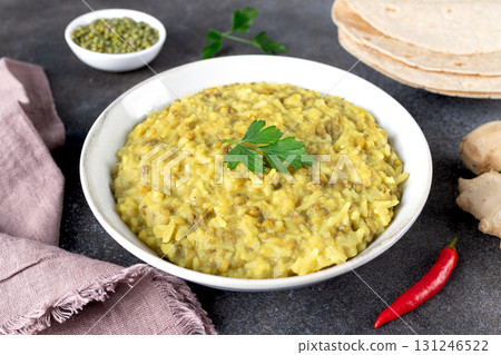 Indian Khichari with rice,lentils served with roti on gray background. Top view. Ayurveda diet 131246522