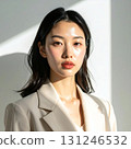 A portrait of a woman in a white suit. Her expression bathed in natural light accentuates her elegance and intellectual aura. 131246532