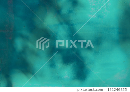 Teal painted wall with soft shadows, moody texture, cracks. Leaf shadow on wall, botanical silhouette, soft sunlight. Leaves form natural pattern. Turquoise wall for creative background 131246855