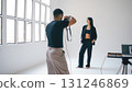 Photographer taking photos of fashion model in studio 131246869