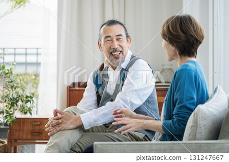 Senior couple having a conversation in the living room at home 131247667