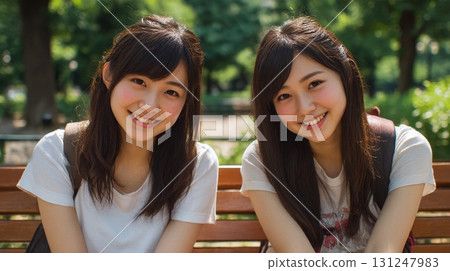 Two close friends sitting on a bench 4 Two close friends sitting on a bench 4 131247983