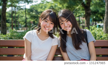 Two close friends sitting on a bench 6 131247985