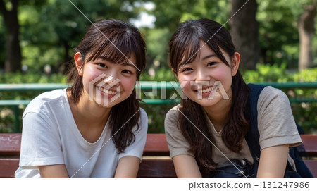 Two close friends sitting on a bench 7 Two close friends sitting on a bench 7 131247986