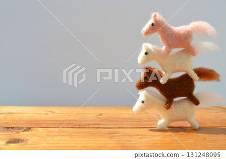 Wool felt horses overlapping 131248095