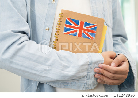 Learn English language, Asian teenage student hold book with flag in course at school. Learn English language, Asian teenage student hold book with flag in course at school. 131248950