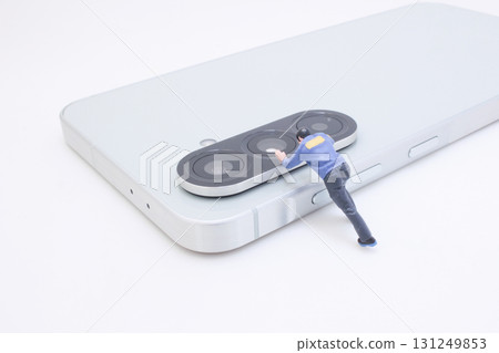Tiny Figure Pushing Camera Lens on Modern Smartphone Tiny Figure Pushing Camera Lens on Modern Smartphone 131249853