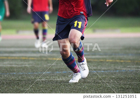 Soccer player chasing the ball 131251051