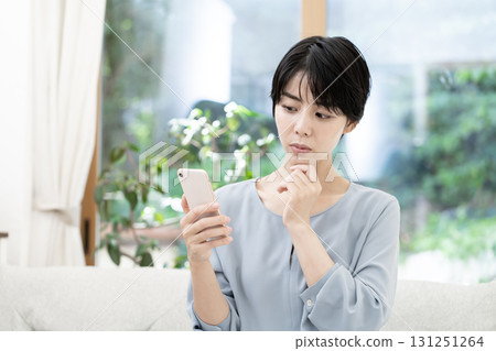 Young woman using a smartphone Young woman using a smartphone 131251264