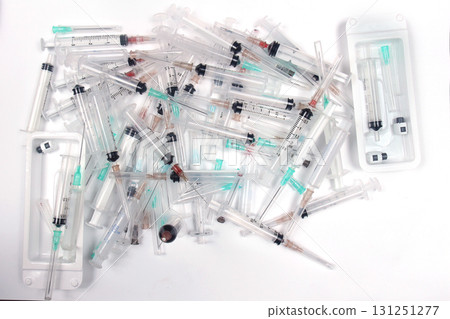Pile of used medical syringes with needles Pile of used medical syringes with needles 131251277