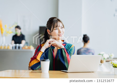 A young woman working in a cafe 131251677