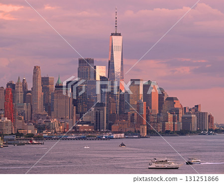 Lower Manhattan illuminated at dusk with purple sky and Hudson River on a foreground 131251866
