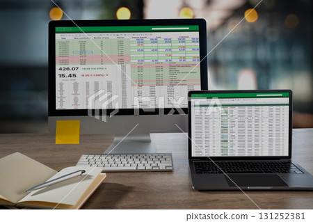 laptop display a detailed spreadsheet with financial figures and color coded rows on a tidy office desk ideal visual for analytics KPI 131252381