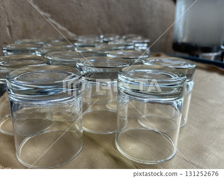 Multiple clear glasses arranged upside down on a surface Multiple clear glasses arranged upside down on a surface 131252676