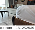 Soft white duvet on a bed in a modern hotel room close up view 131252680