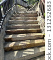 Stone steps with wooden railings ascend a scenic outdoor pathway 131252683