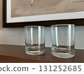 Two clear empty glasses on a wooden surface indoors 131252685