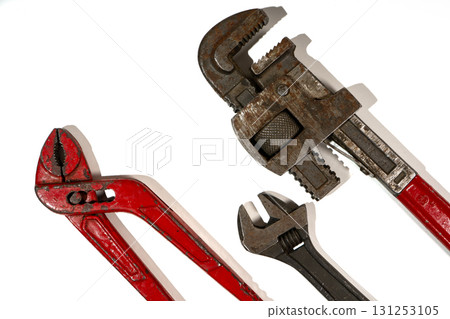 Adjustable pipe wrench, water pump pliers and monkey wrench lying on a white background Adjustable pipe wrench, water pump pliers and monkey wrench lying on a white background 131253105