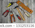 Assorted work tools lying on rustic wooden table 131253116