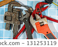 Plumbing tools laying on blue tiles ready for a plumber to use 131253119