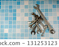Wrenches lying on blue tiles representing plumbing and maintenance 131253123