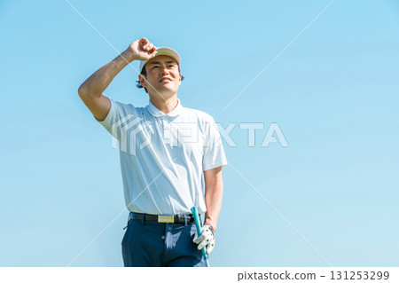 A golfer man playing golf on a golf course (smile) A golfer man playing golf on a golf course (smile) 131253299