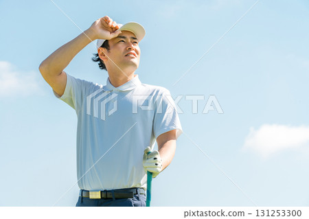 A golfer man playing golf on a golf course (smile) A golfer man playing golf on a golf course (smile) 131253300