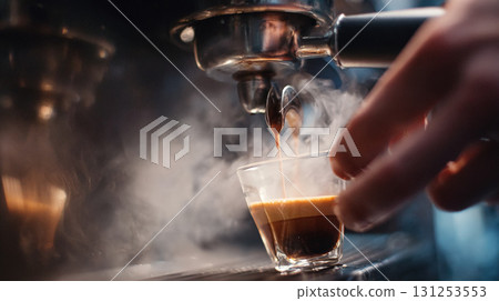 First-person view of espresso shot brewing with crema and steam rising First-person view of espresso shot brewing with crema and steam rising 131253553