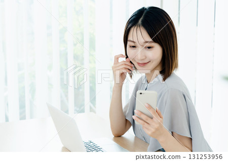 A young lady with a smartphone 131253956