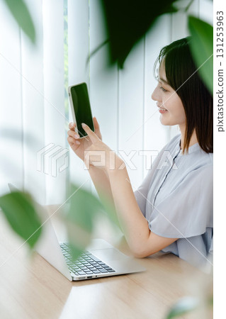 A young lady with a smartphone 131253963
