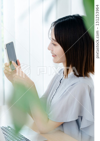 A young lady with a smartphone A young lady with a smartphone 131253964