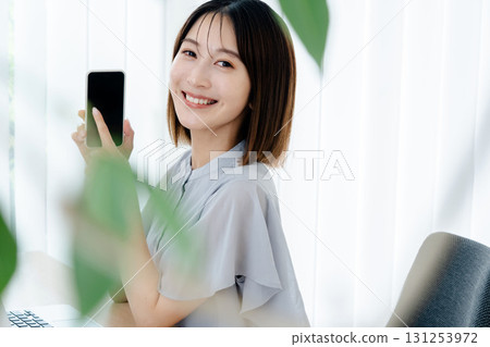A young lady with a smartphone 131253972