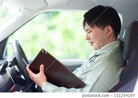 A contractor reading materials during a tour 131254197