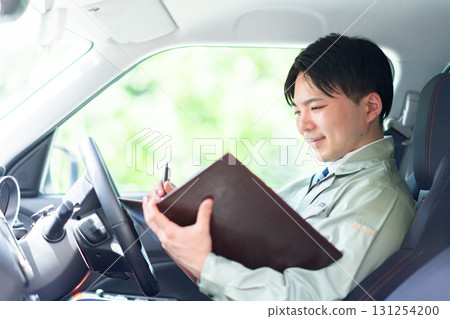 A contractor reading materials during a tour 131254200