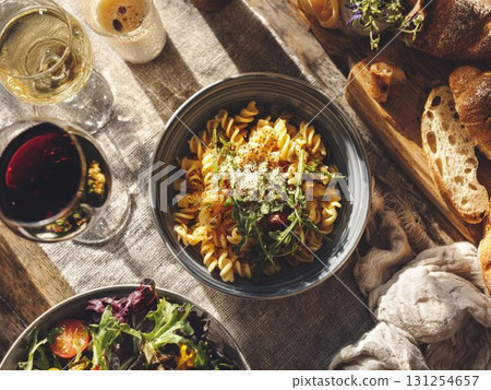 豐富多彩的晚餐,包括義大利麵、葡萄酒、麵包和沙拉 豐富多彩的晚餐,包括義大利麵、葡萄酒、麵包和沙拉 131254657