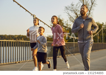 Happy active family in sportswear running together in the park having sport workout outdoors. Happy active family in sportswear running together in the park having sport workout outdoors. 131254893