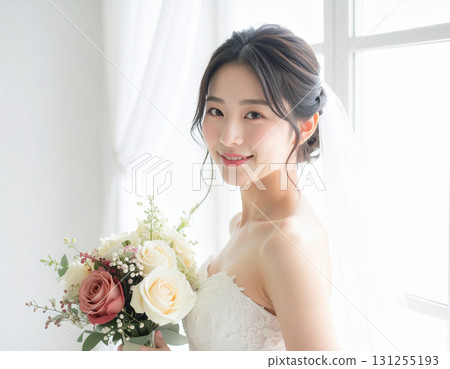 A young woman in a dress holding a bouquet 131255193