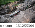 Underground Utility Pipes Exposed During Street Excavation 131255309