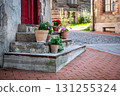 Colorful Potted Flowers on Rustic Old Stone Steps 131255324