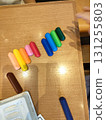 Colorful crayons lined up on a table 131255803