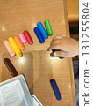 Colorful crayons lined up on a table 131255804
