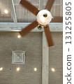A ceiling light with a windmill attached to the ceiling 131255805