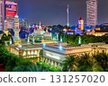 Colorful cityscape at night with brightly illuminated Jamek Mosque and Sultan Abdul Samad Building with clock tower. High-rises, Malaysian flag, modern contrast, traditional culture, architecture 131257020