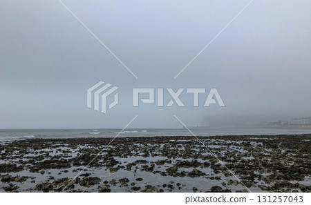 Waves washing over rocks in the ocean at a beach in Normandy, France Waves washing over rocks in the ocean at a beach in Normandy, France 131257043